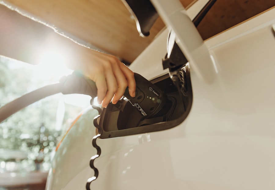 Hand plugging an EV charging cable